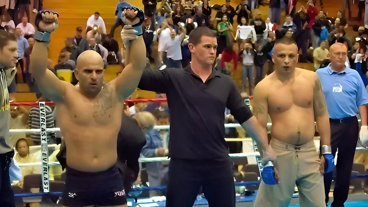 Master Chim in the ring after a fight, the referee raising his arm