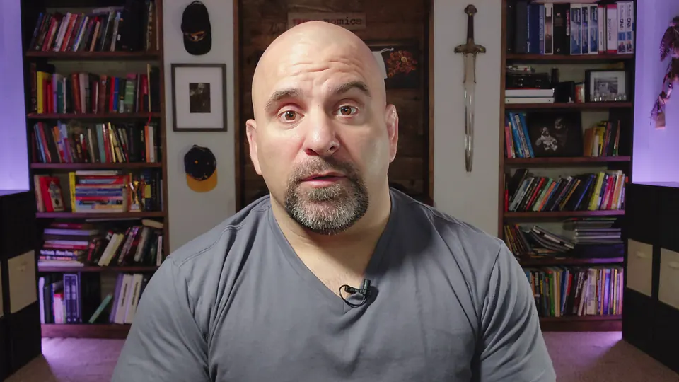 Master Chim talking to the camera in front of his bookshelves