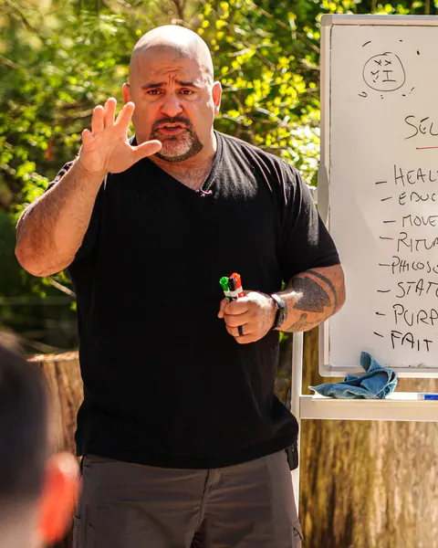Master Chim teaching the Three Roads, one hand raised