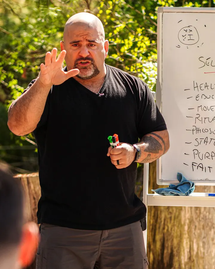 Master Chim teaching the Three Roads, one hand raised
